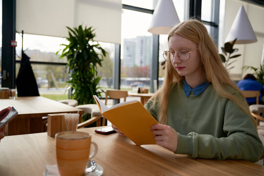 Young woman is reading book