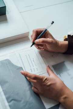 Image of Hands Writing Title of Architectural Project