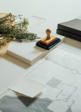 Office Table With Dried Flowers and Architectural Plans