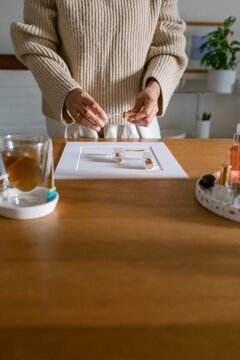 Female placing props and samples at desk