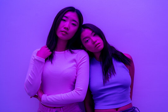 Portrait Of Two asian Girlfriends Looking At The Camera