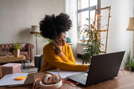 Woman Using Phone While Using Computer