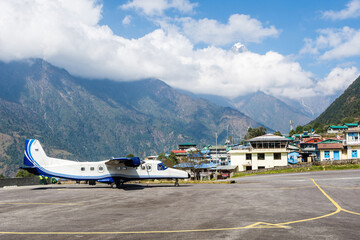 Fototapeta na wymiar Twin turboprop airplane in Tenzing-Hillary Lukla airport, Lukla, Nepal