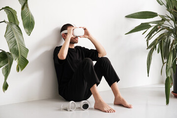 Young man puts on VR headset