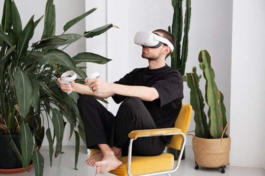 Man playing with VR headset and joysticks