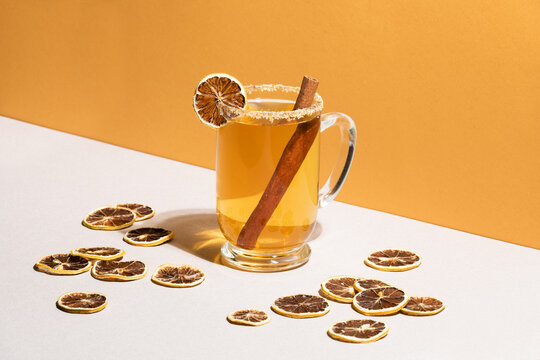 Hot golden tea with dried lemon slices.