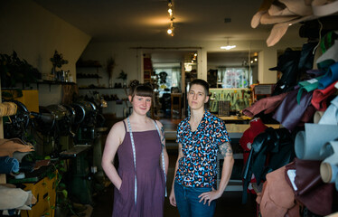 Two people in a shoe and leather goods repair shop.