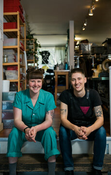 Two people in a shoe and leather goods repair shop.