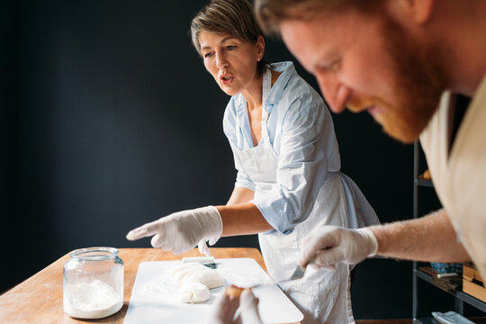 Man and Woman Working in Bakery 