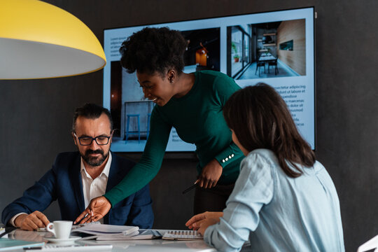 Smiling Businesswoman Working With Her Co-Workers