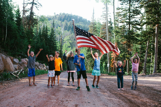 Cousins And Kids Cheer With Happiness With American Flag