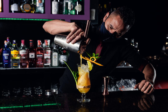 professional bartender preparing cocktails at the bar