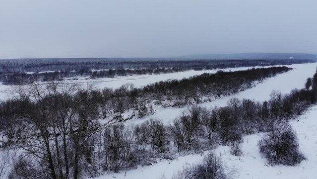 Icy Winter River with Snowy Forest Aerial View