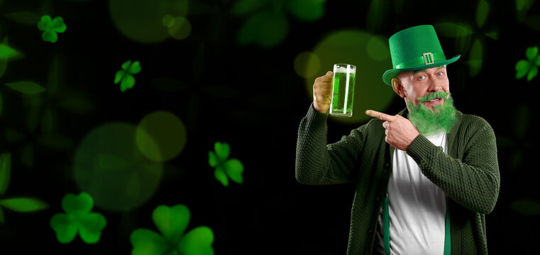 Funny mature man with green beer on dark background. Banner for St. Patrick's Day