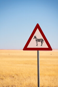 Zebra crossing danger sign in a grassy plain in Namibia, Africa
