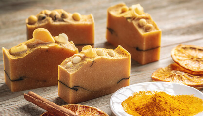 Natural orange soap on the wooden background. Concept of making and using organic eco soap and cosmetics
