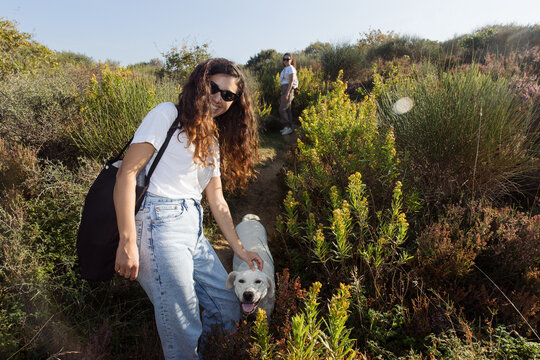 Two women walking their dog