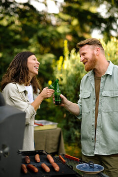 Man and Woman Toasting at Barbecue Party 