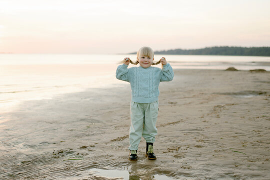 Cute happy girl posing on a sandy beach