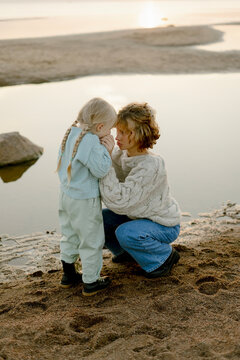 Little daughter touch  face of loving mommy showing love
