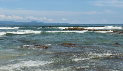 Blue waves traveling to the shore.