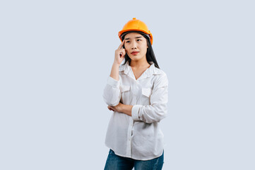 Young female engineer in helmet stand with thoughtful posture