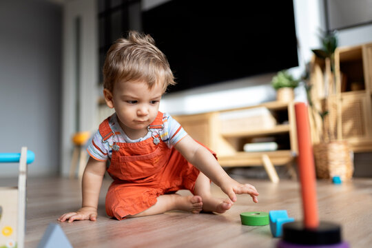 Happy Toddler playing with Toys