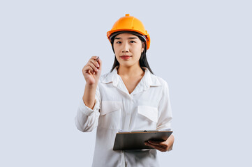 Young female engineer wearing Yellow helmet and clipboard