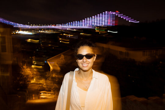 Portrait Of A Woman Wearing Sunglasses At Night