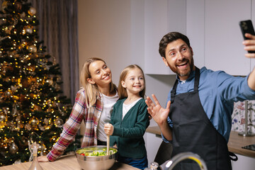 Take photo selfie cook dinner Christmas tree eve  happy family