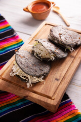 Gordita de Chicharron. Blue Cornmeal dough stuffed with chicharron prensado. Traditional Mexican appetizer commonly accompanied by cilantro, onion and hot sauce.