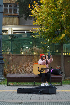Female vlogger preparing for busking in city park