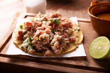 Taco de Carnitas. Cornmeal tortilla with deep fried pork. Traditional Mexican appetizer commonly accompanied by cilantro, onion and hot sauce.
