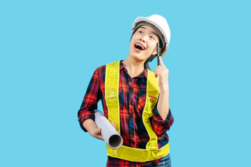 Young asian engineer female wearing safety jacket and helmet hold blue print