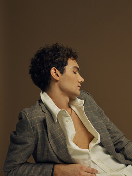 Pensive man with unbuttoned shirt