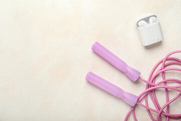 Skipping rope with earphones on white background
