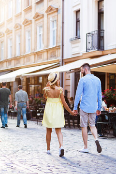 couple in love are walking in the middle of the city in summer