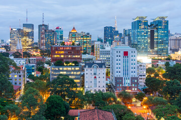 Elevated view of high rise buildings with city lights on at Ho Chi Mihn City in Vietnam
