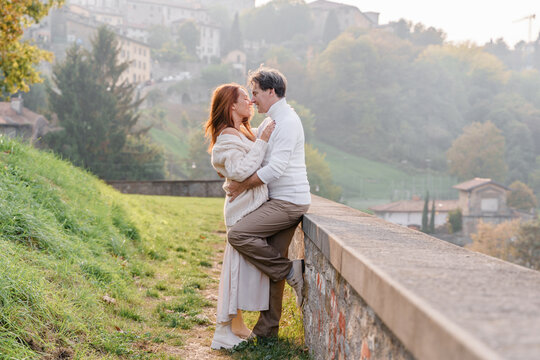 Loving couple husband and wife are smiling, hugging and look at