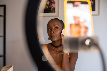African American vlogger showing powder to cellphone