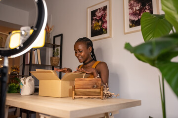 Glad beauty blogger looking inside box