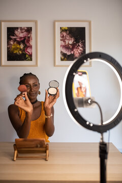 Black influencer showing cosmetic supplies