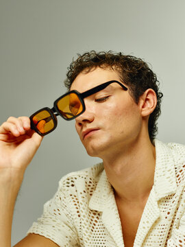 Man taking out sunglasses