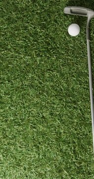 Vertical viedo of golf ball and club on grass, copy space, slow motion