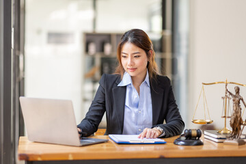 Business Asian woman in suit and Lawyer working on a documents at workplace office. Judge gavel with Justice lawyers,  Legal law, advice  and justice concept