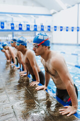 hispanic team of teenagers swimming athletes wearing cap and goggles in a swimming training In the Pool in Mexico Latin America	