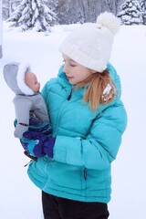 girl and her doll in winter