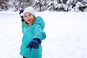 girl playing with snowball