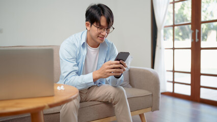 Happy Confident young asian business man use the smartphone. business successful technology concept