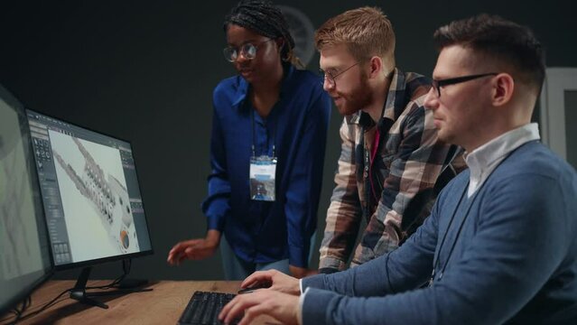 international team of engineers working in office, men and woman creating 3D visualization